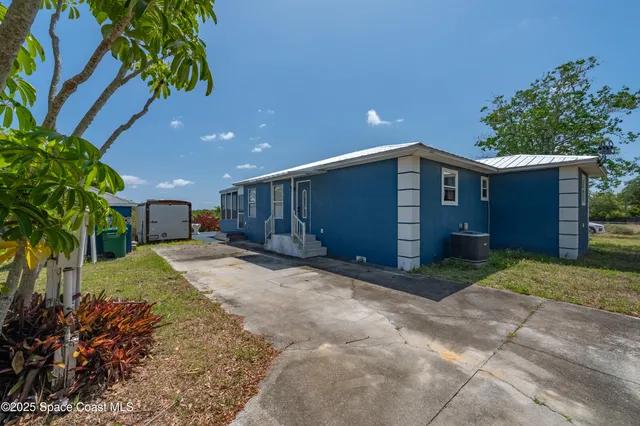 a backyard of a house with a garden and entertaining space