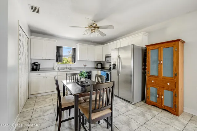 a kitchen with stainless steel appliances granite countertop a refrigerator and a stove top oven