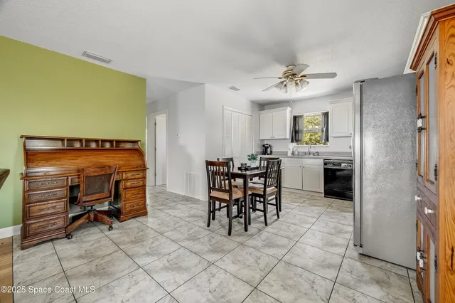 a view of a dining room with furniture and a chandelier