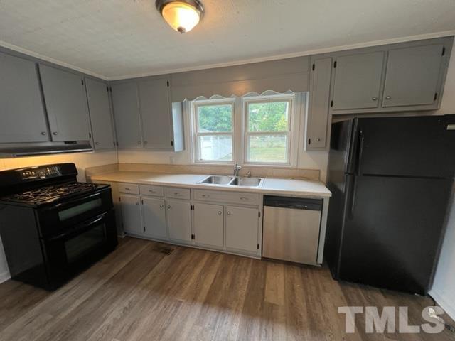 301 North 16th Street Erwin, NC 28339 - Photo 4 of 21 a kitchen with a sink stove and refrigerator