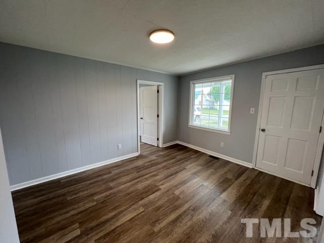 301 North 16th Street Erwin, NC 28339 - Photo 6 of 21 a view of an empty room with wooden floor and a window