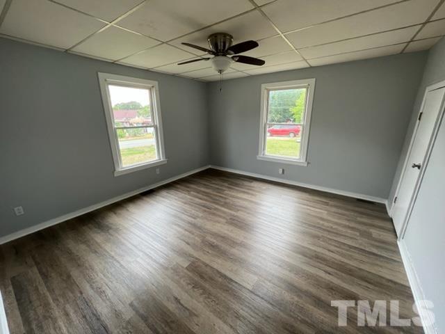 301 North 16th Street Erwin, NC 28339 - Photo 9 of 21 a view of an empty room with wooden floor and a window
