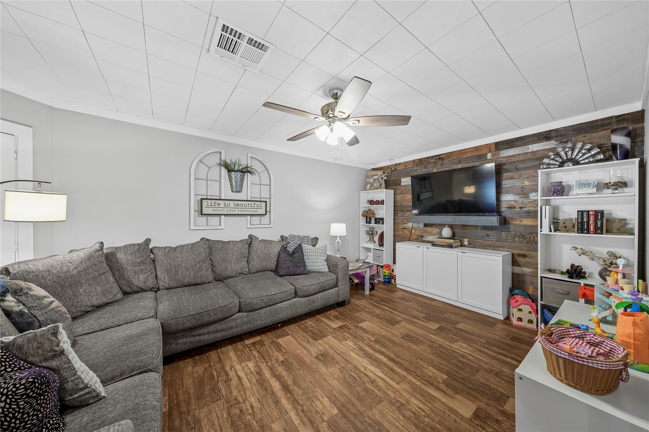 3027 Poppy Street Needville, TX 77461 - Photo 12 of 41 a living room with furniture and a flat screen tv