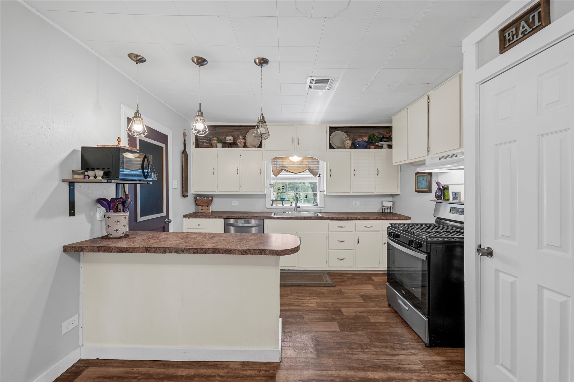 3027 Poppy Street Needville, TX 77461 - Photo 15 of 41 a kitchen with a sink stove and refrigerator