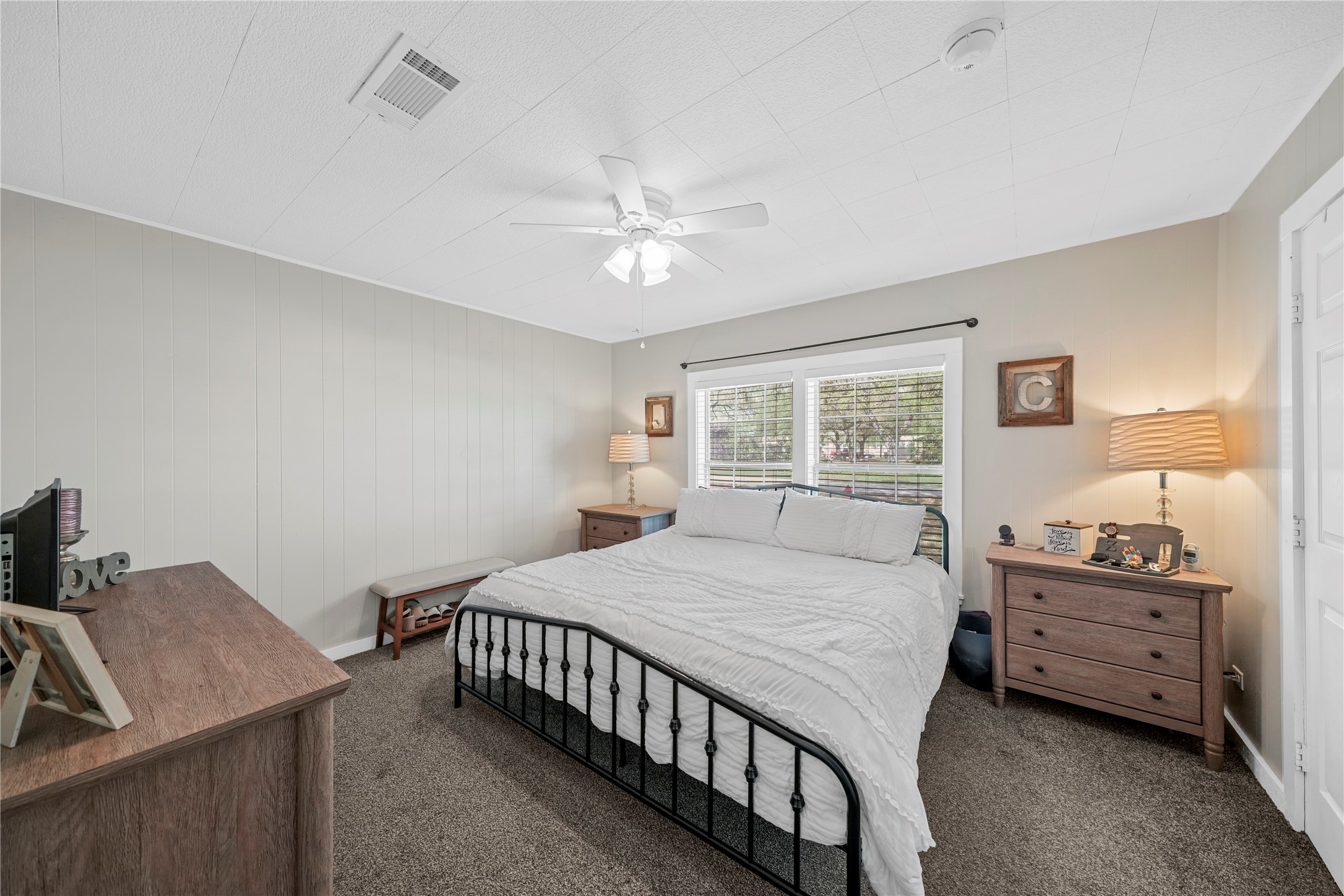 3027 Poppy Street Needville, TX 77461 - Photo 18 of 41 a bedroom with a bed chandelier and a window