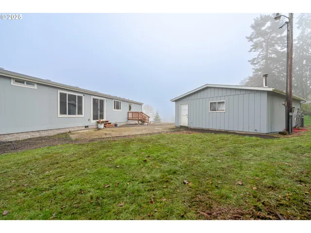 a view of an house with backyard space and balcony