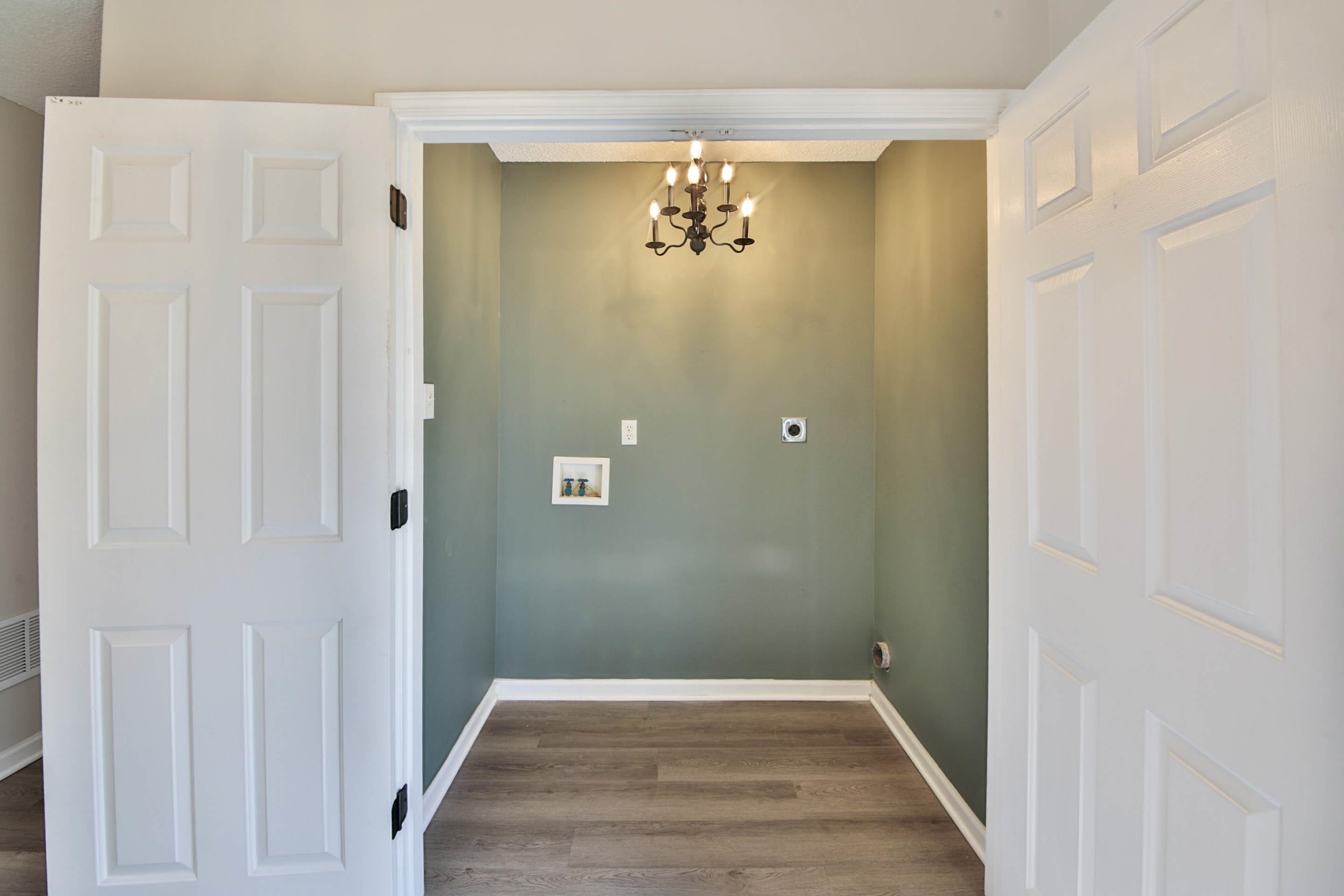 125 Pine Ridge Lane Oakland, TN 38060 - Photo 12 of 24 Laundry room with a chandelier, hookup for a washing machine, dark wood-style floors, and electric dryer hookup