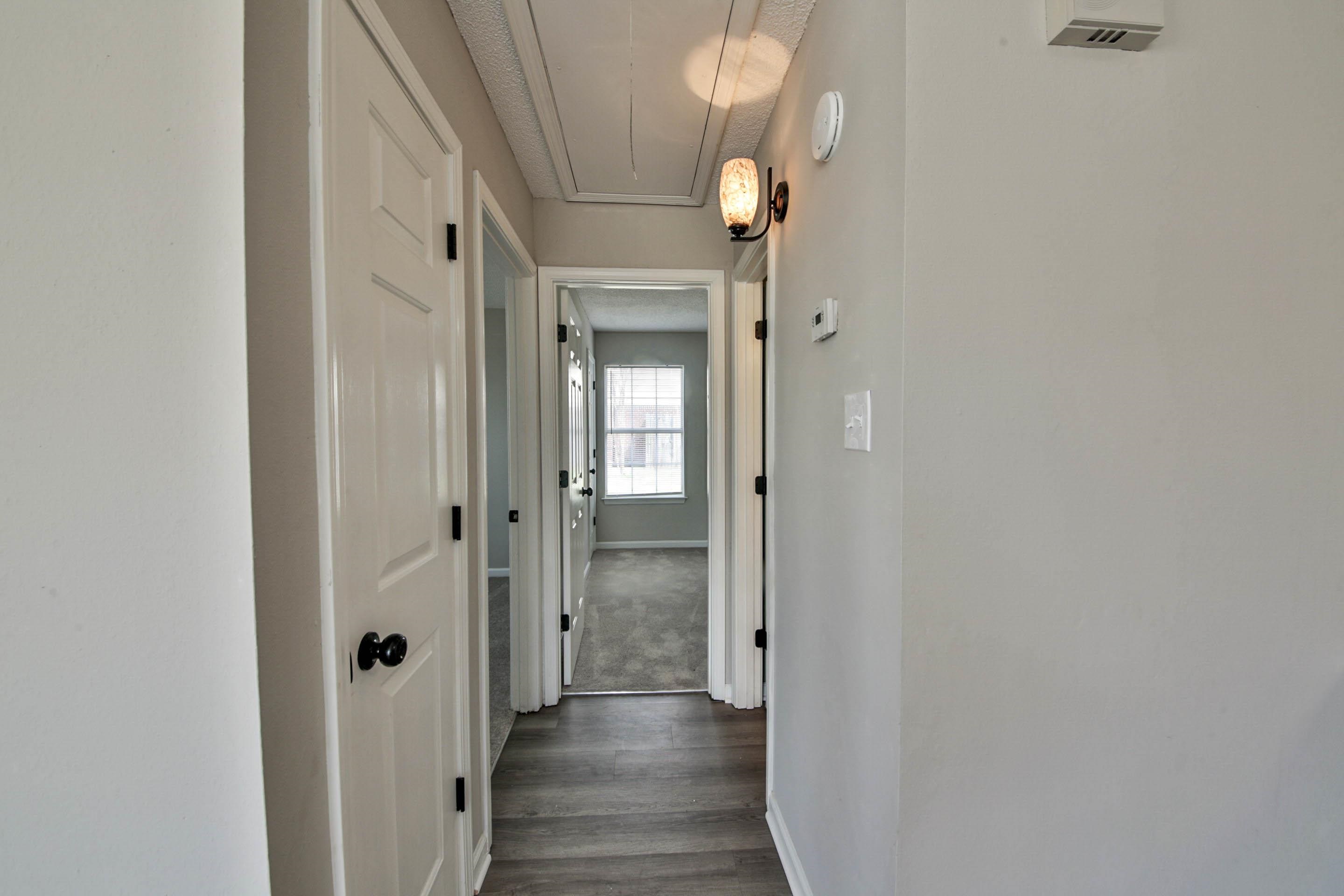 125 Pine Ridge Lane Oakland, TN 38060 - Photo 14 of 24 Corridor featuring dark wood-style floors and a textured ceiling