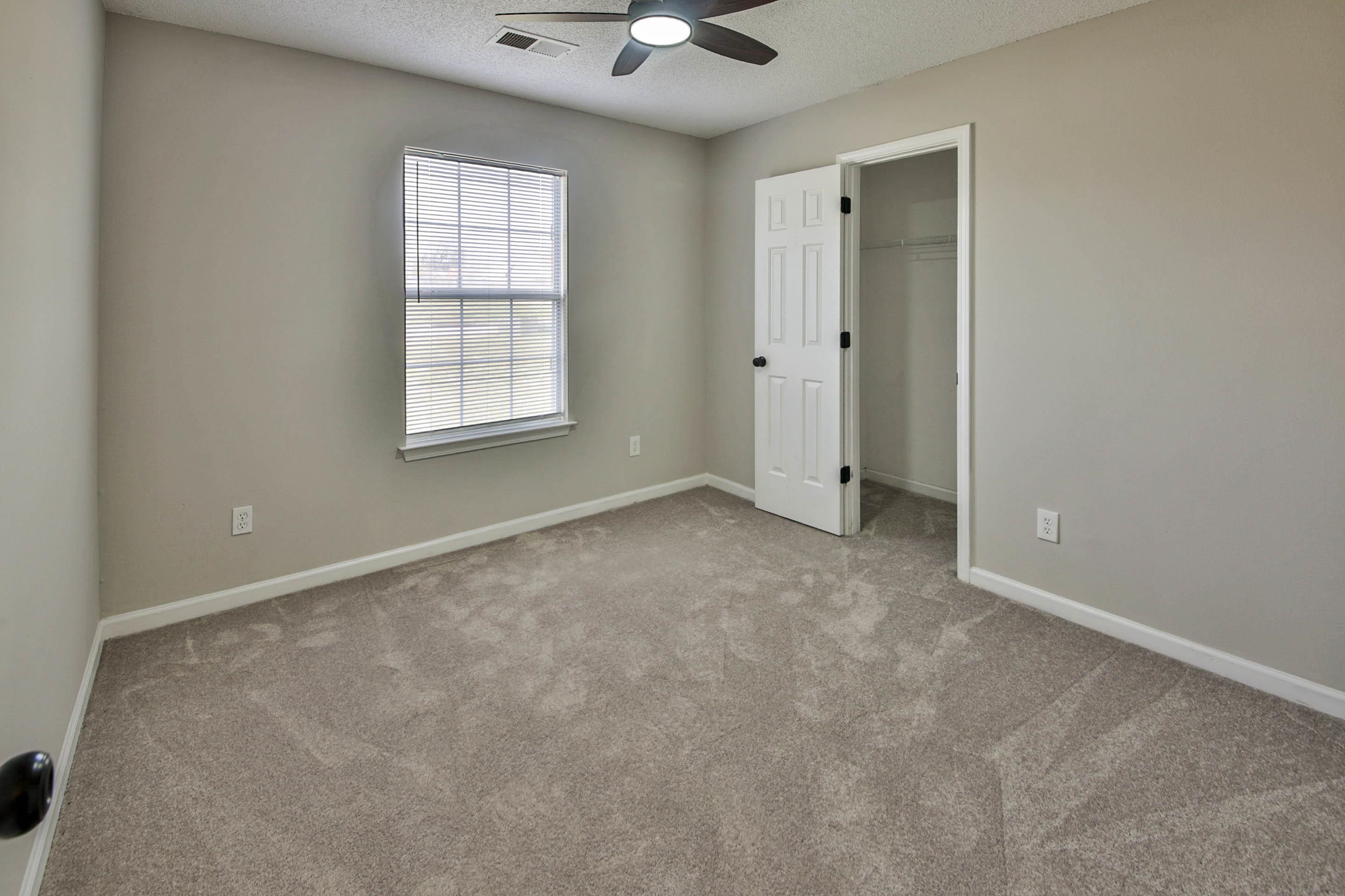 125 Pine Ridge Lane Oakland, TN 38060 - Photo 16 of 24 Unfurnished bedroom featuring a spacious closet, light colored carpet, a textured ceiling, and a ceiling fan