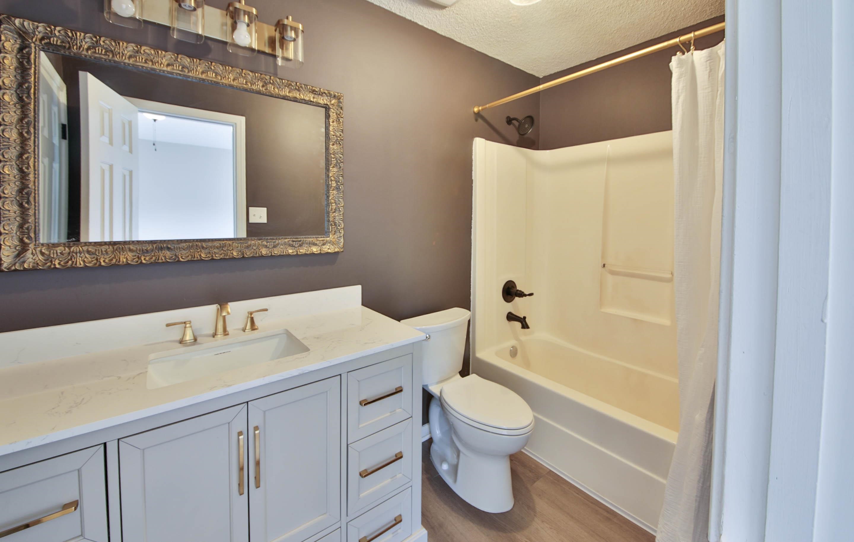 125 Pine Ridge Lane Oakland, TN 38060 - Photo 19 of 24 Bathroom with vanity, a textured ceiling, shower / bath combination with curtain, and light wood-style floors