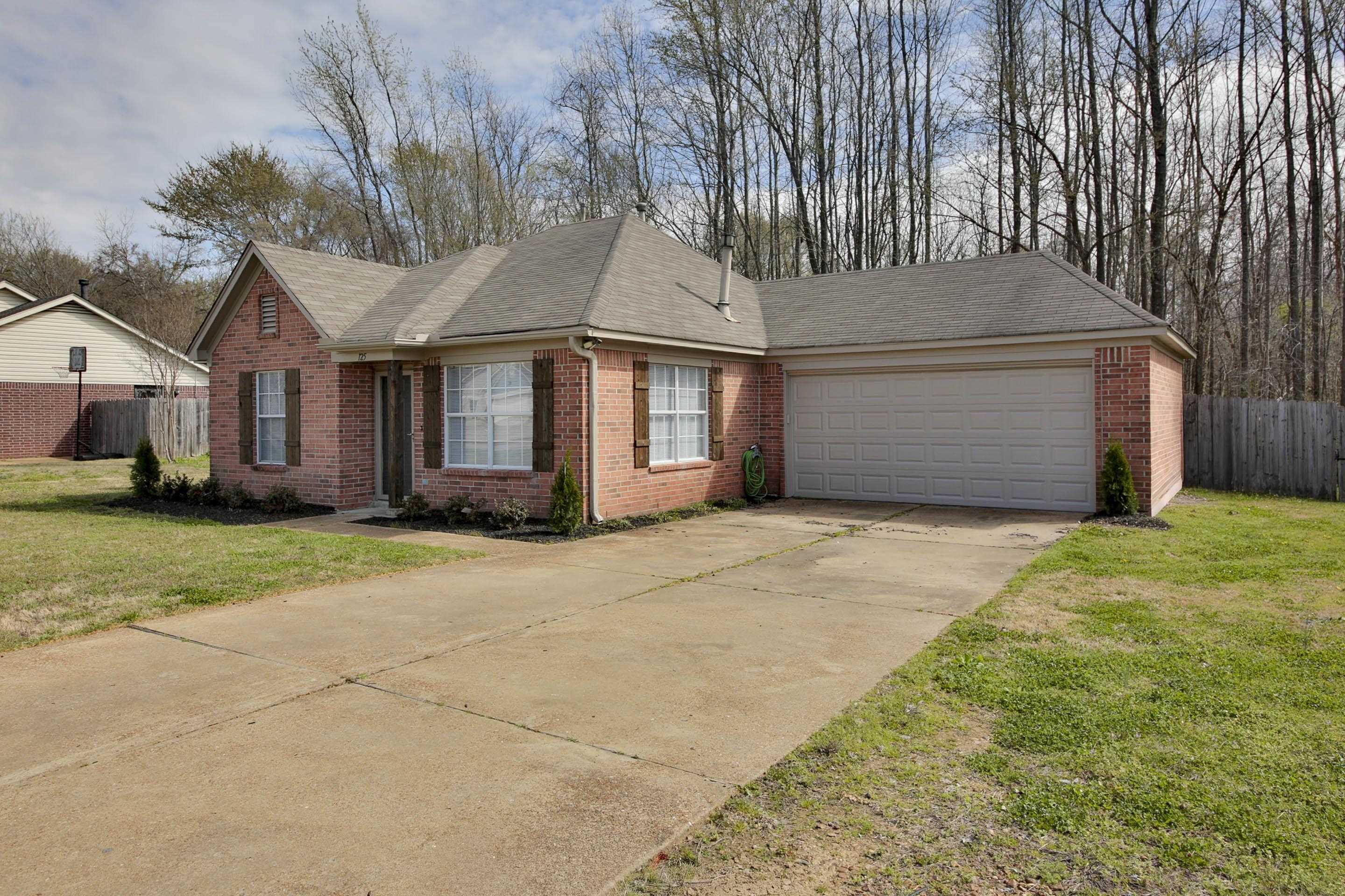 125 Pine Ridge Lane Oakland, TN 38060 - Photo 2 of 24 Ranch-style house featuring a shingled roof, brick siding, an attached garage, and concrete driveway