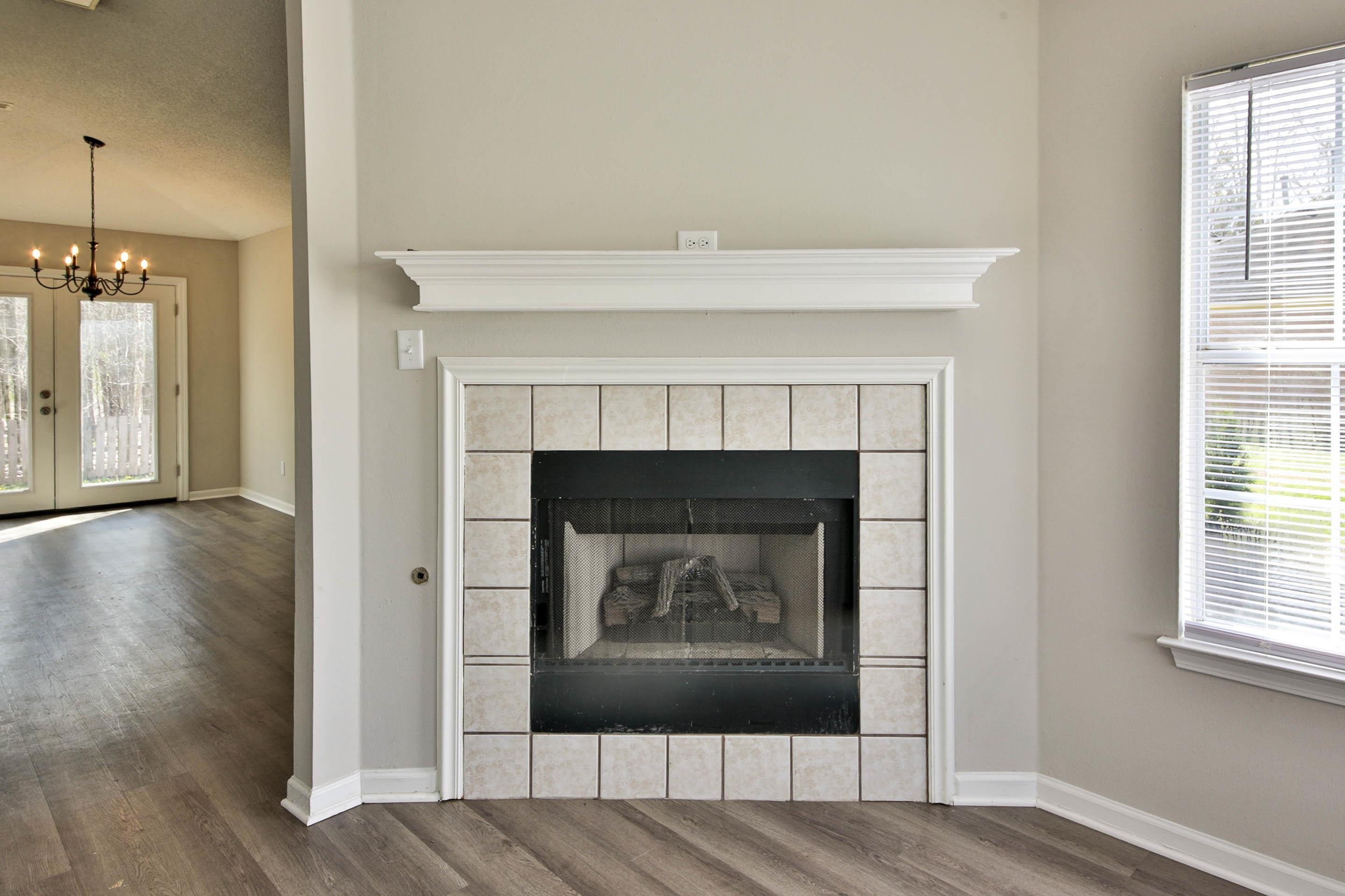 125 Pine Ridge Lane Oakland, TN 38060 - Photo 6 of 24 Detailed view of wood finished floors, suspended lighting, a tile fireplace, and french doors