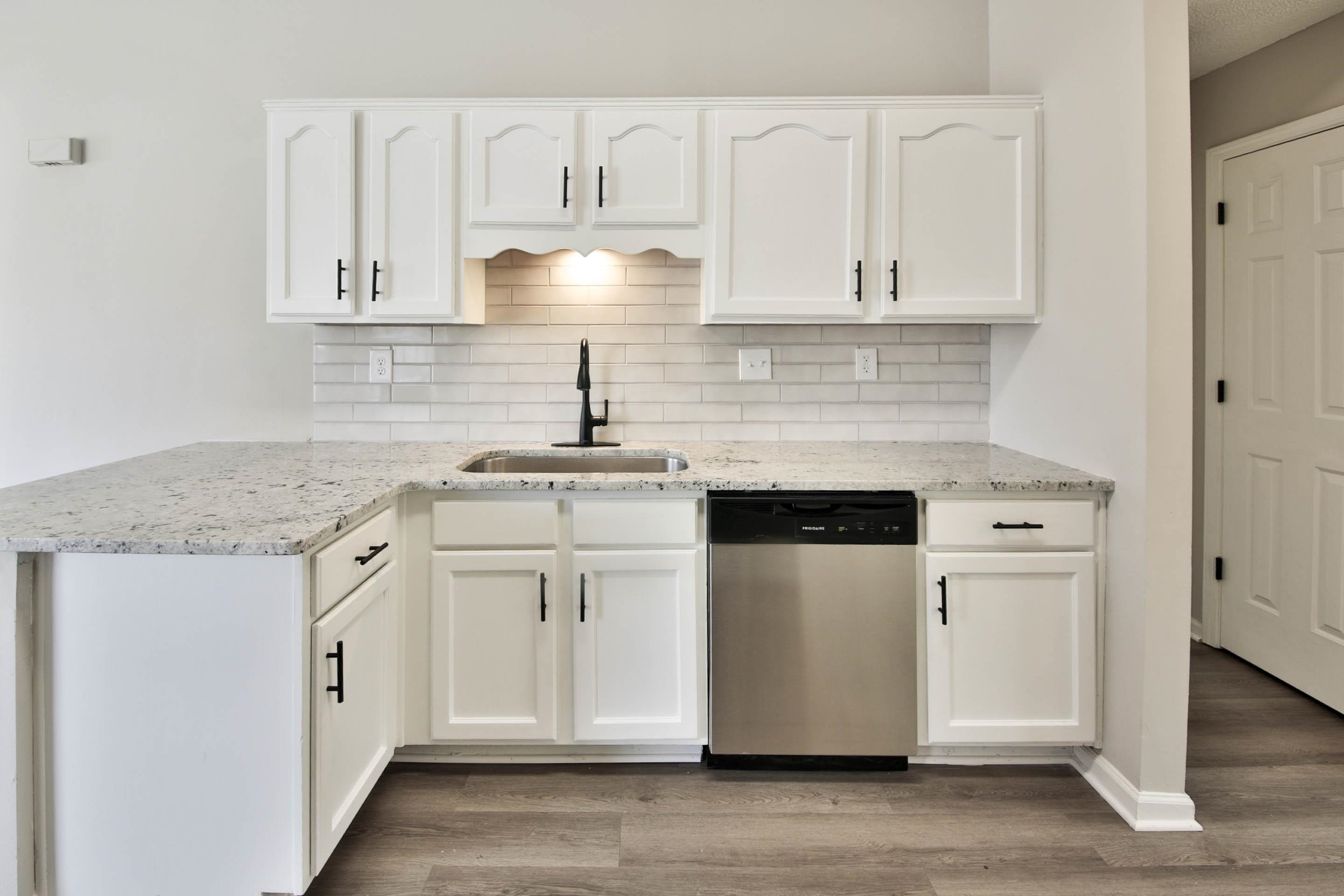 125 Pine Ridge Lane Oakland, TN 38060 - Photo 9 of 24 Kitchen featuring white cabinetry, dishwasher, and light stone counters