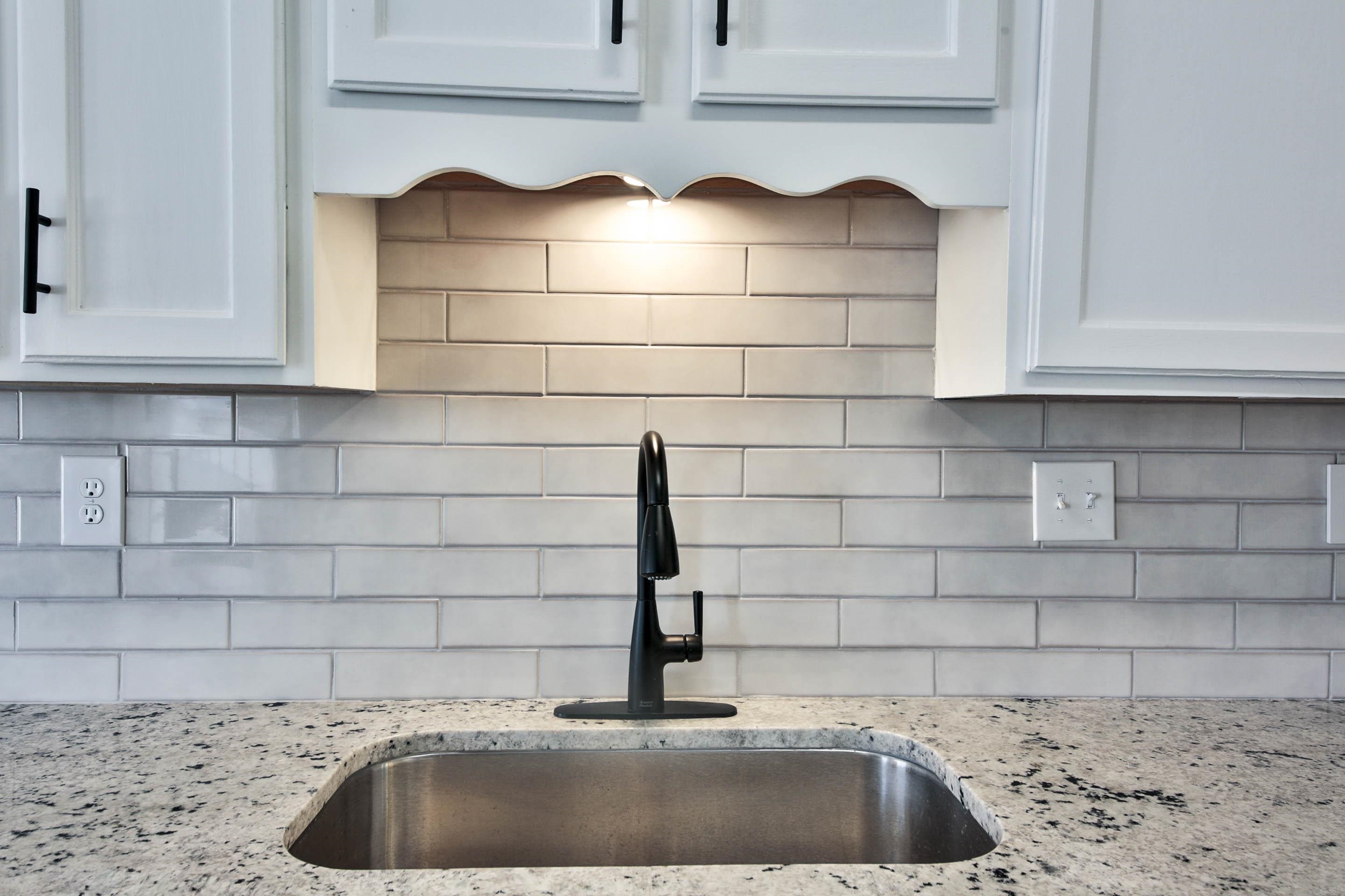 125 Pine Ridge Lane Oakland, TN 38060 - Photo 10 of 24 Kitchen view of light stone countertops, white cabinets, and tasteful backsplash