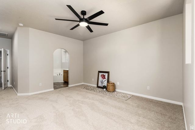 2158 Balboa Way St. George, UT 84770 - Photo 15 of 40 Unfurnished bedroom with ensuite bath, carpet, ceiling fan, and arched walkways