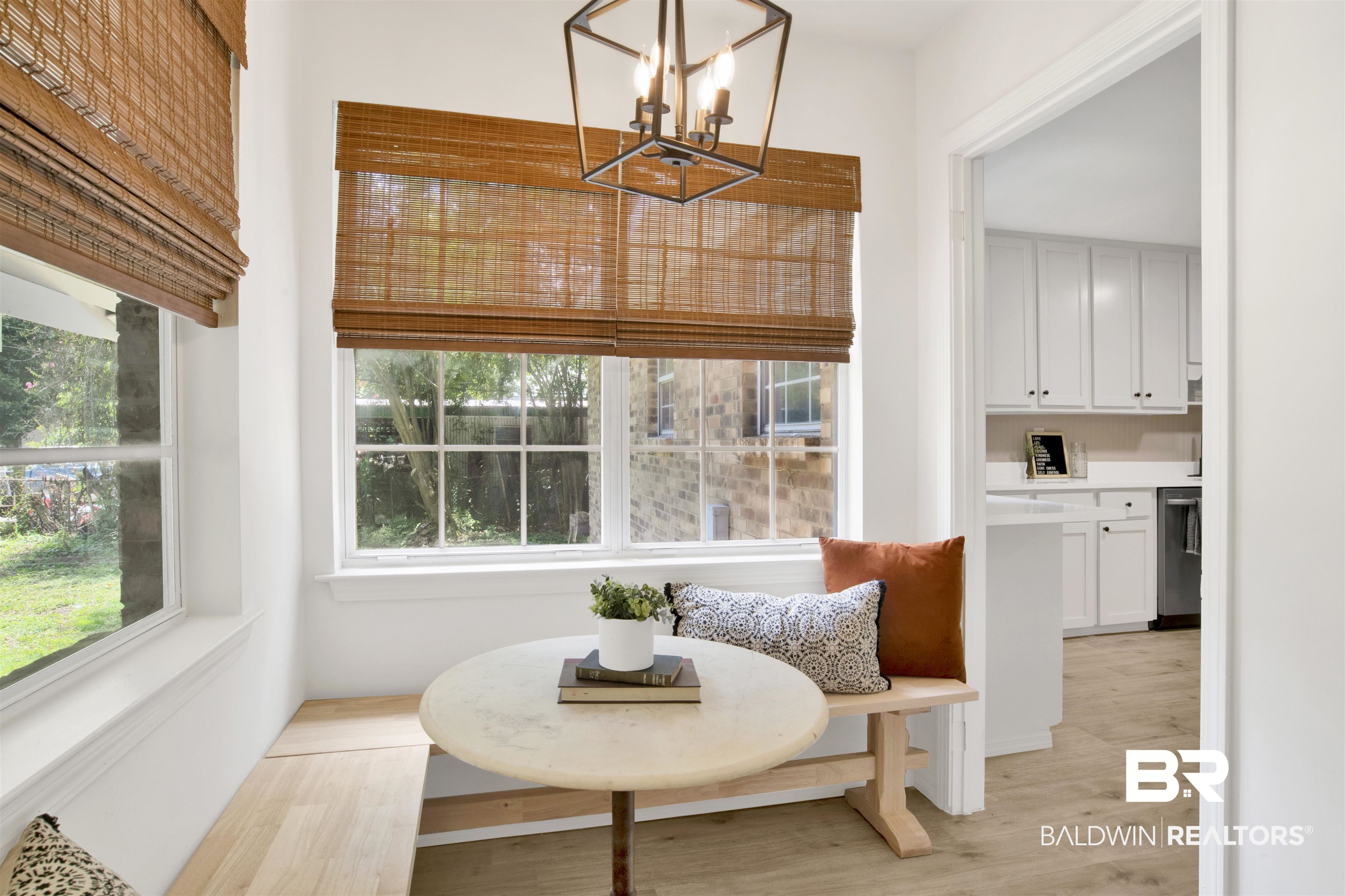 317 Lee Street Chickasaw, AL 36611 - Photo 12 of 40 Breakfast space with light wood finished floors and a chandelier