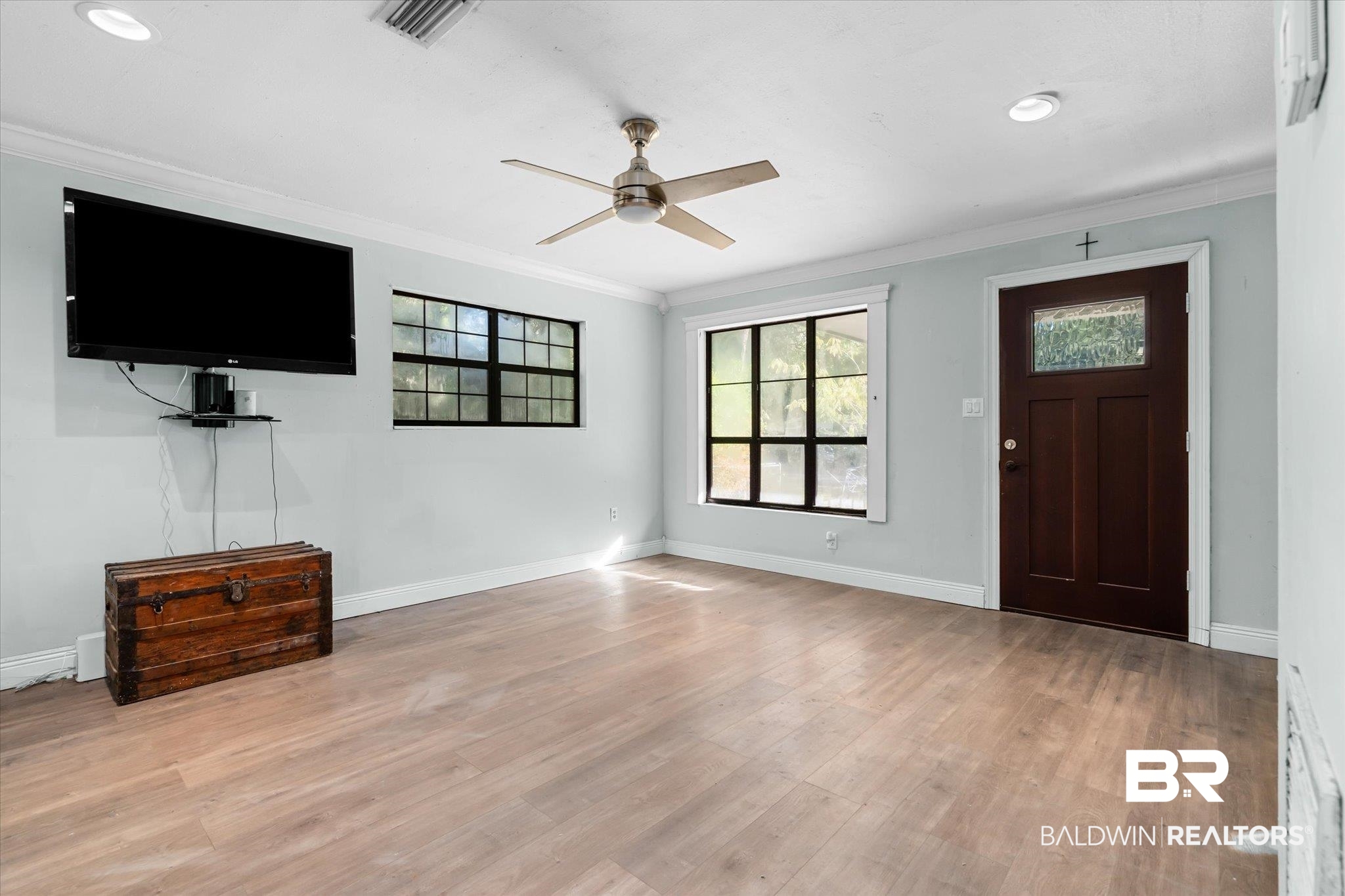 6233 Ponder Road Fairhope, AL 36532 - Photo 4 of 20 Entrance foyer with ceiling fan, light hardwood / wood-style floors, and crown molding