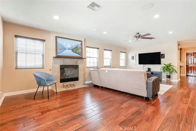 a living room with furniture fireplace and flat screen tv