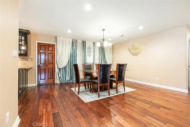 a view of a dining room with furniture and wooden floor