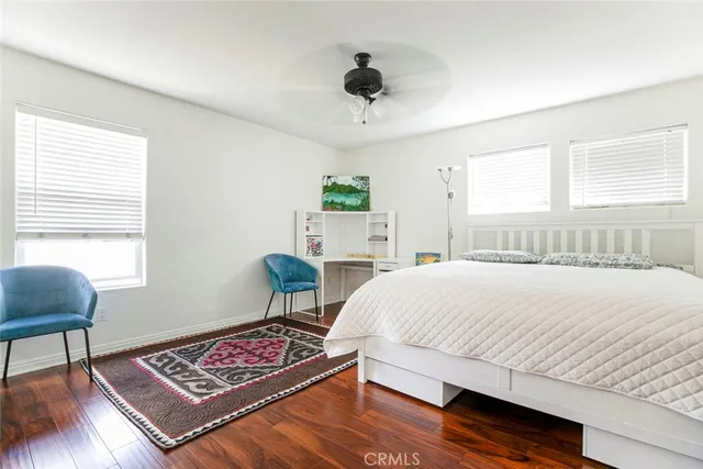 a bedroom with a bed a table and chair