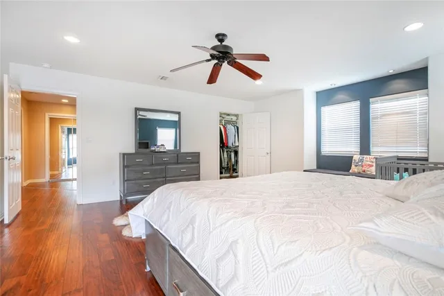 a bedroom with a bed and a large mirror