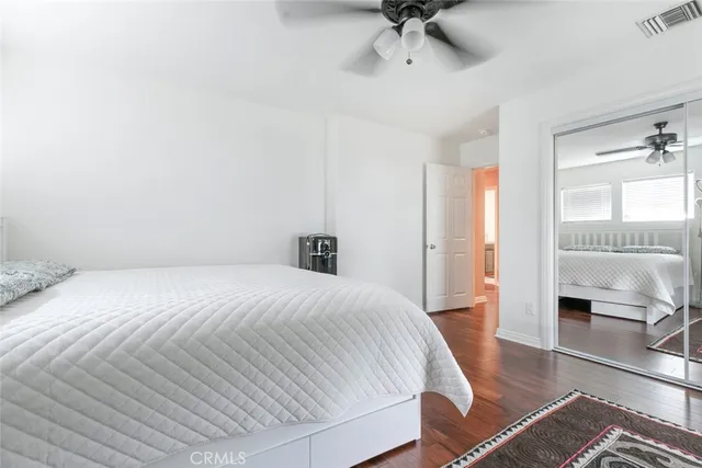 a spacious bedroom with a bed and a chair