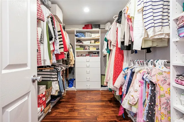 a view of walk in closet with clothes