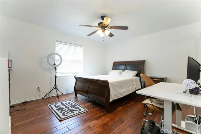 a bedroom with bed and a chandelier
