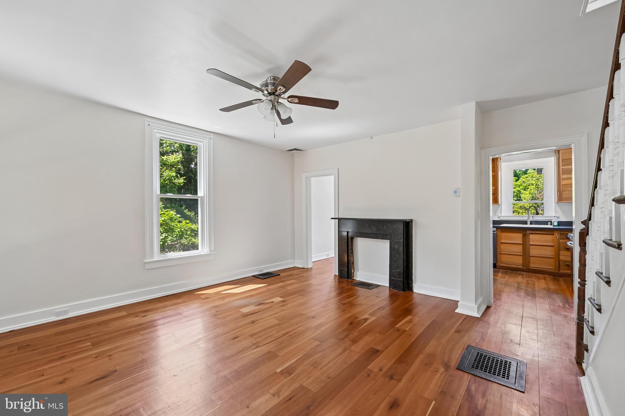 5702 Falls Road Baltimore, MD 21209 - Photo 2 of 49 a view of empty room with wooden floor and fireplace