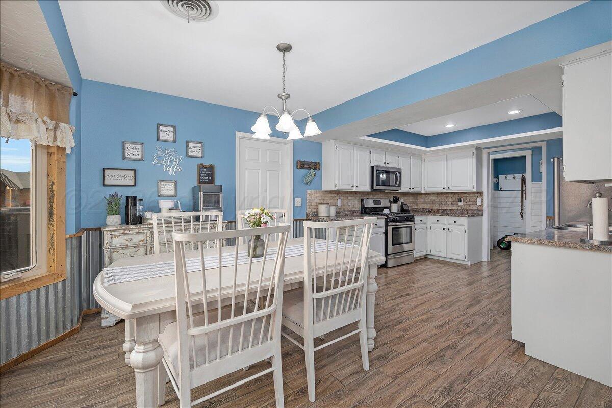 6912 Manor Circle Amarillo, TX 79109 - Photo 11 of 25 a view of a dining room with furniture and wooden floor