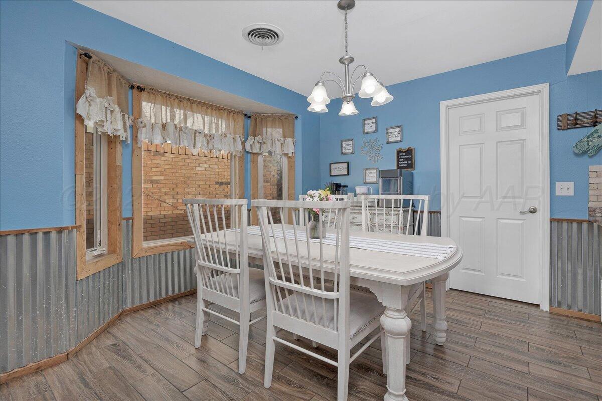 6912 Manor Circle Amarillo, TX 79109 - Photo 12 of 25 a view of a dining room with furniture window and wooden floor