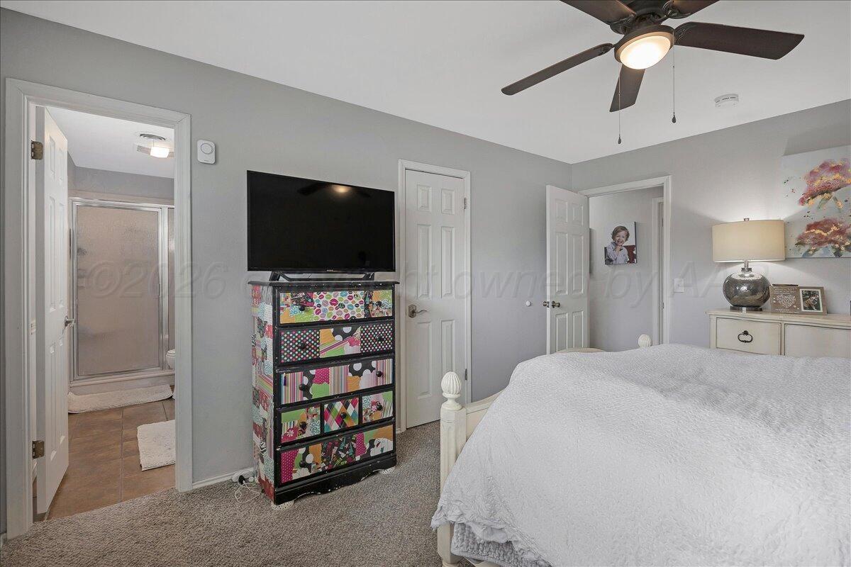6912 Manor Circle Amarillo, TX 79109 - Photo 14 of 25 a bedroom with a bed and a flat screen tv