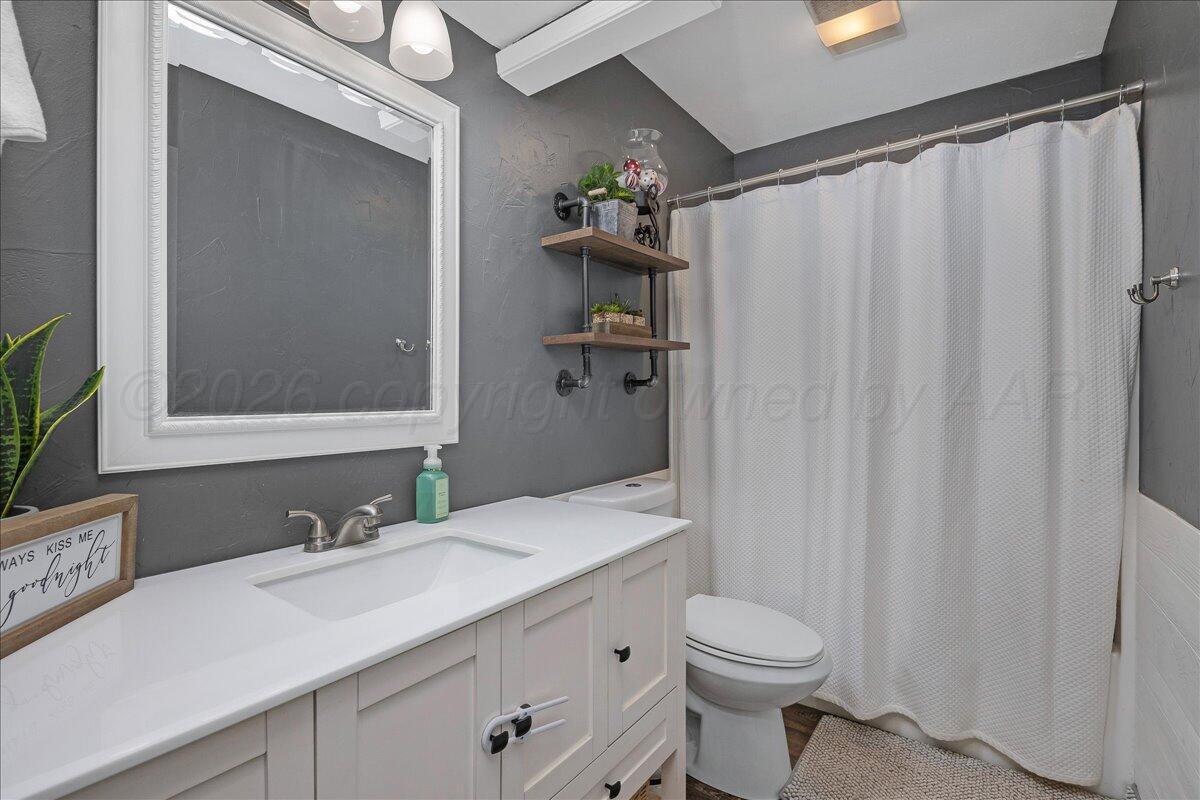 6912 Manor Circle Amarillo, TX 79109 - Photo 17 of 25 a bathroom with a sink a toilet and shower
