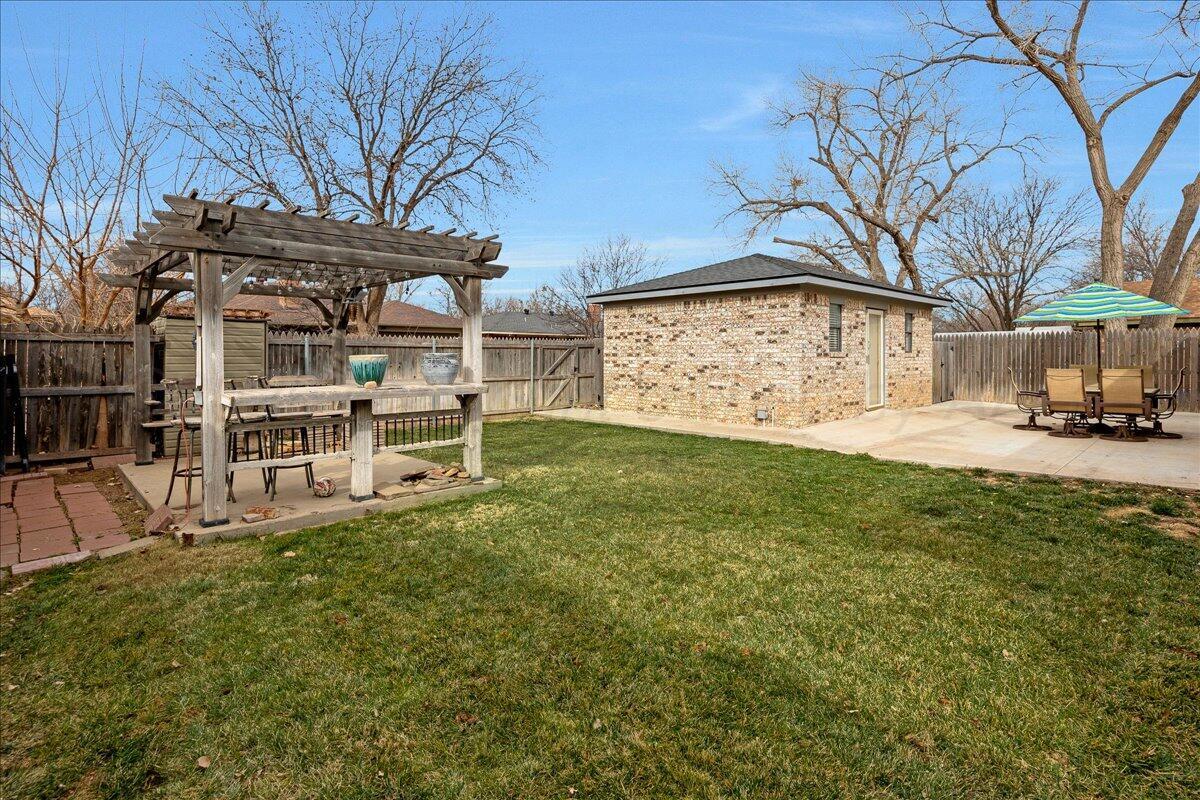 6912 Manor Circle Amarillo, TX 79109 - Photo 24 of 25 a view of a house with a big yard and large tree