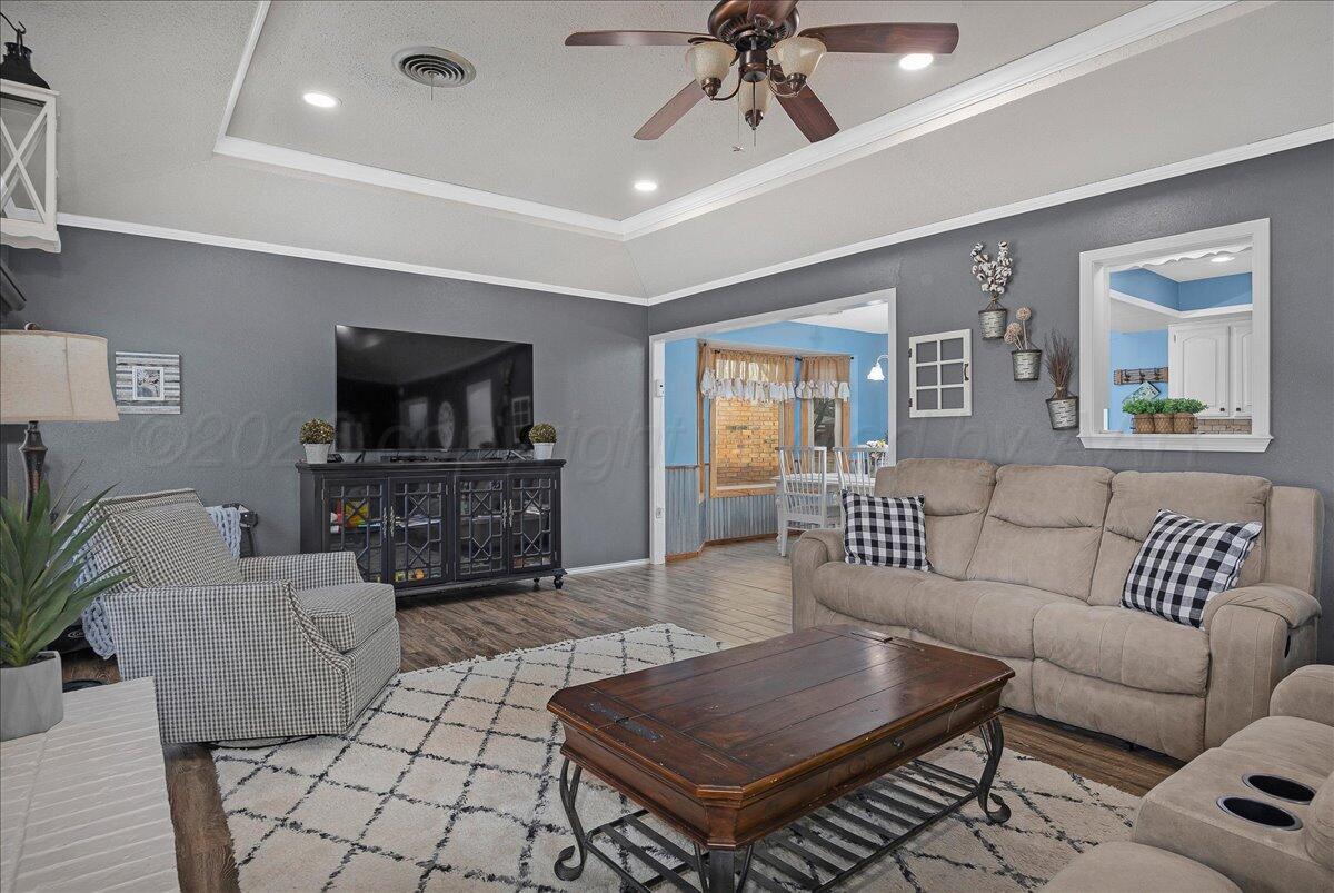 6912 Manor Circle Amarillo, TX 79109 - Photo 6 of 25 a living room with furniture and a flat screen tv