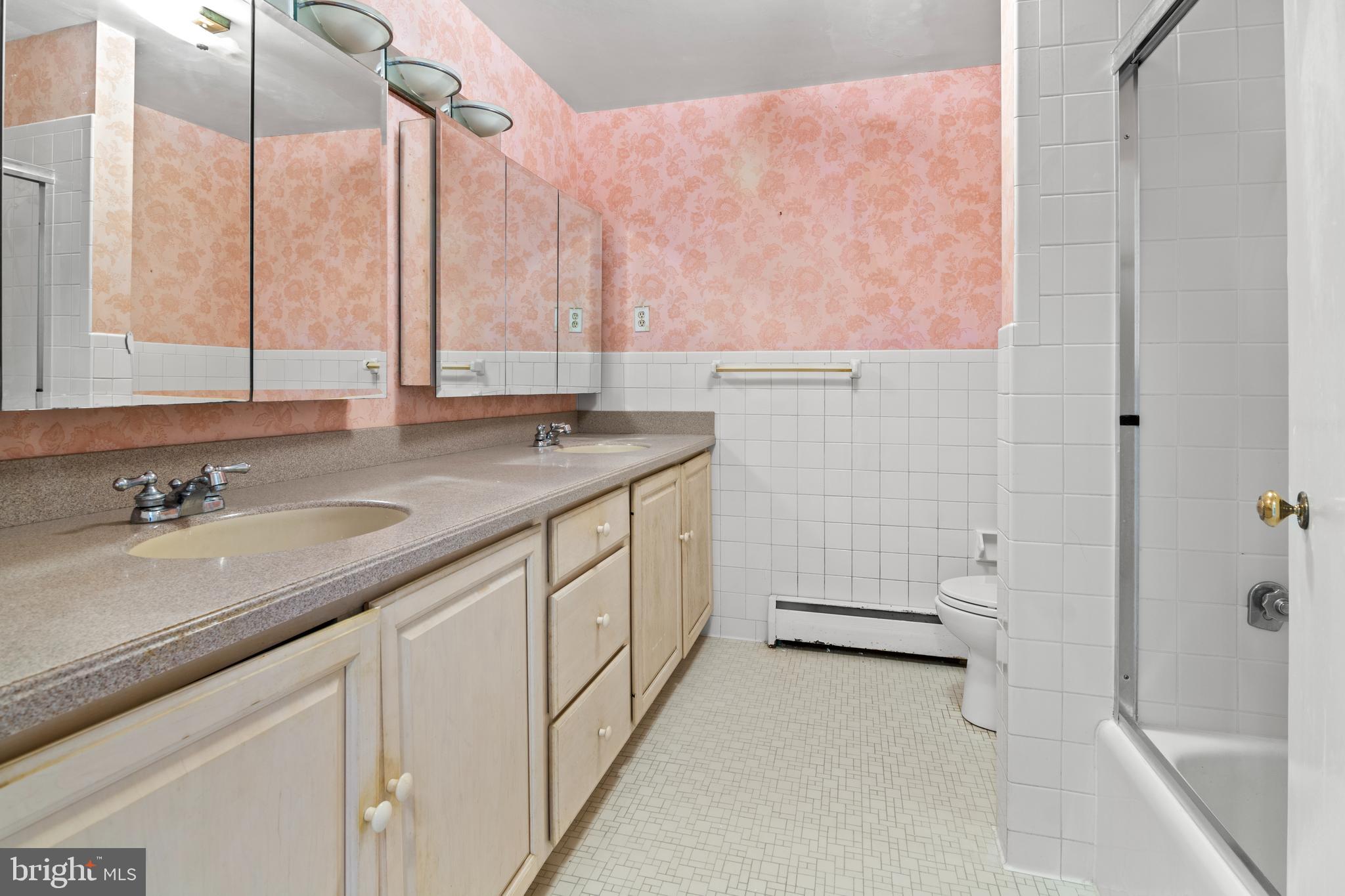 11 Slade Avenue, Unit 712 Baltimore, MD 21208 - Photo 23 of 30 a bathroom with a granite countertop sink a toilet and bathtub