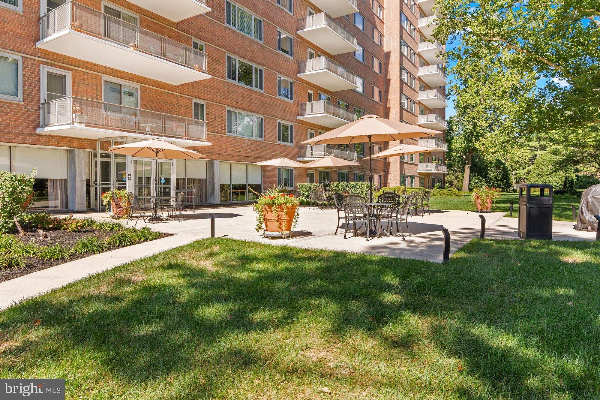11 Slade Avenue, Unit 712 Baltimore, MD 21208 - Photo 28 of 30 a view of a building with a yard and sitting area