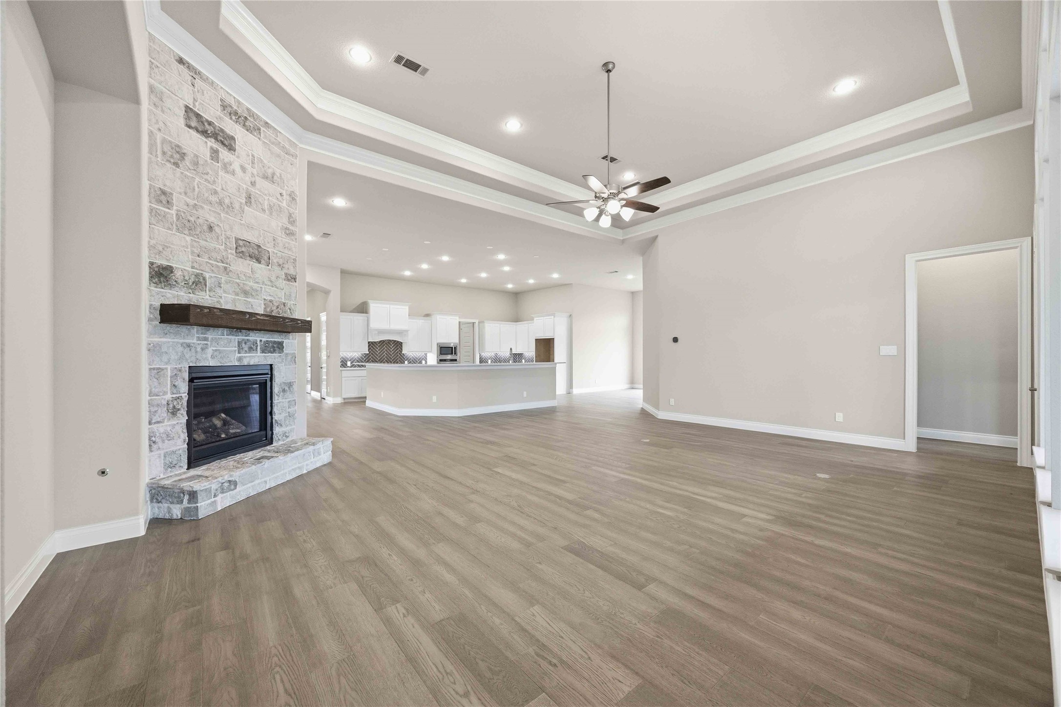 17564 Watercolor Way Conroe, TX 77302 - Photo 10 of 42 Elegant living room offers cozy fireplace, open concept and sweeping views of the backyard