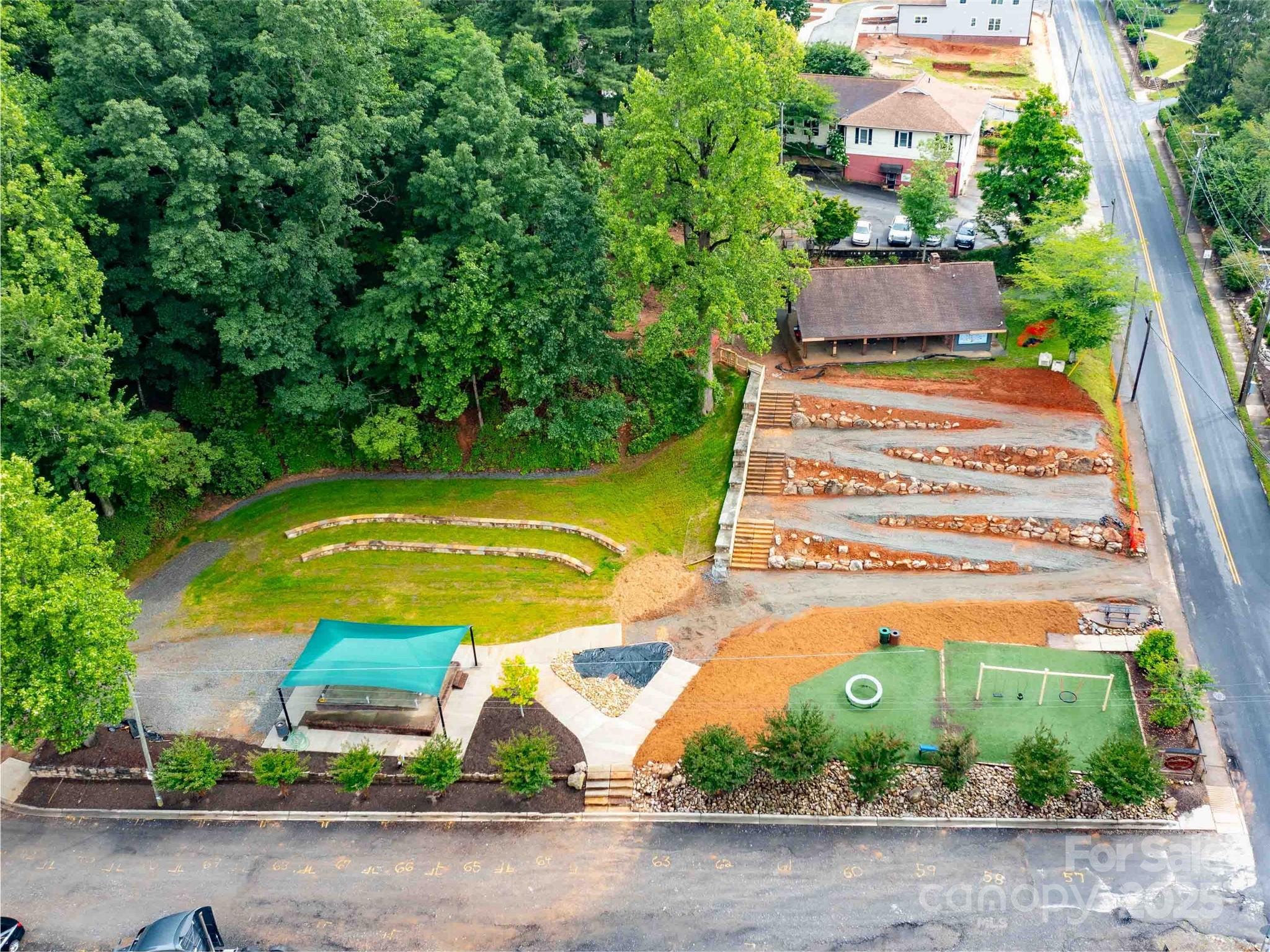0 Mountain Page Road, Unit 17 18 19 Saluda, NC 28773 - Photo 34 of 42 a view of a swimming pool with a yard and plants