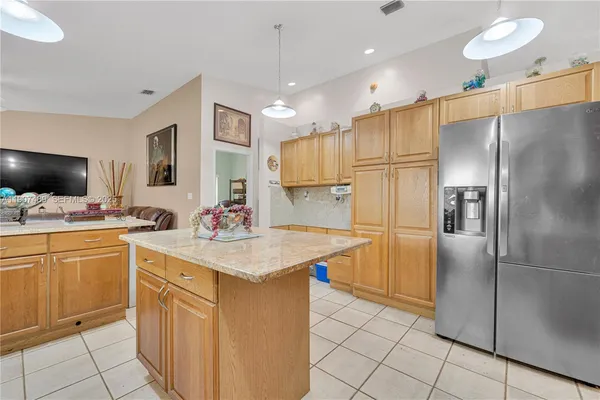 a kitchen with stainless steel appliances a refrigerator sink and microwave
