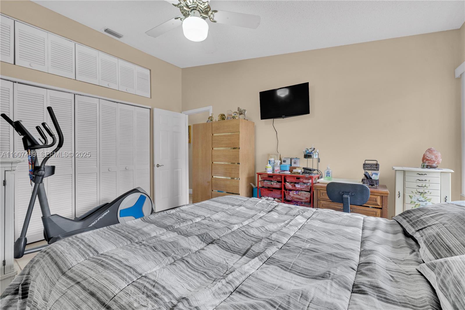 11041 Southwest 138th Avenue Miami, FL 33186 - Photo 23 of 33 a bedroom with a bed and a flat tv screen on dresser