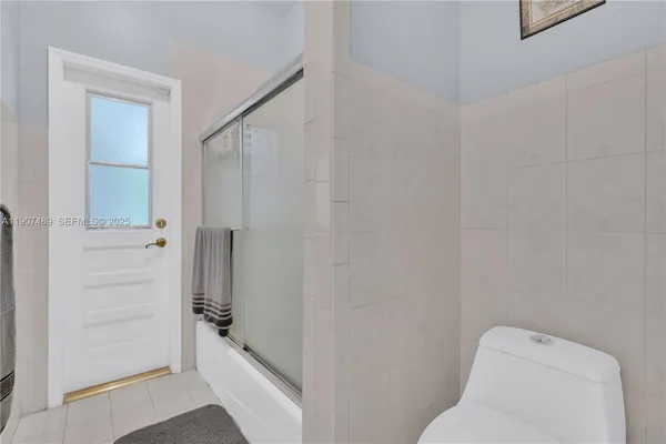 a bathroom with a shower and toilet