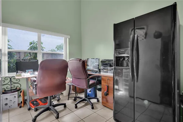 a view of a workspace with furniture and a window