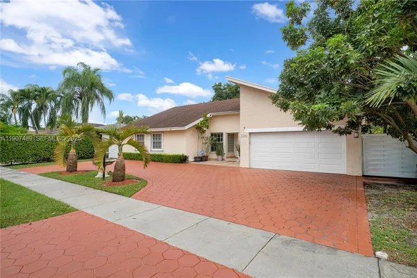 a front view of house with yard and trees