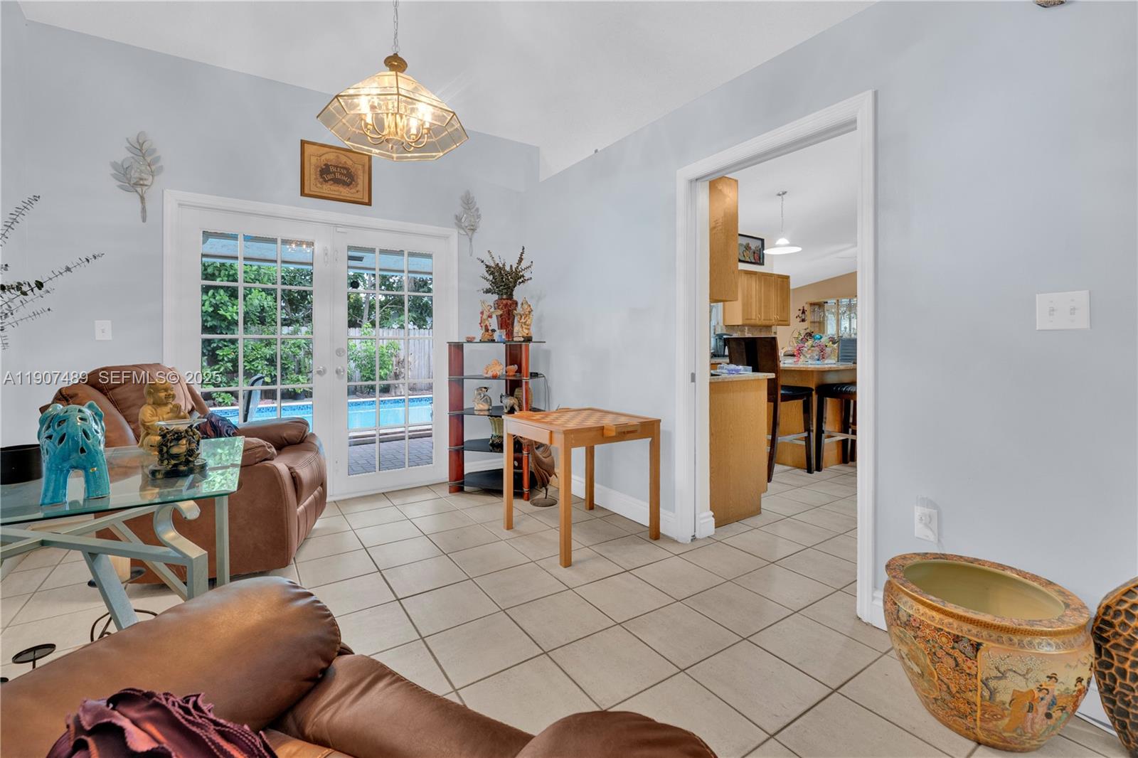 11041 Southwest 138th Avenue Miami, FL 33186 - Photo 10 of 33 a living room with furniture and a chandelier