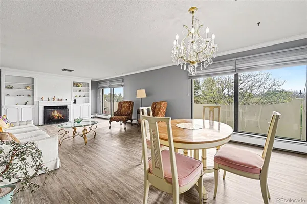 a view of a dining room with furniture wooden floor and chandelier