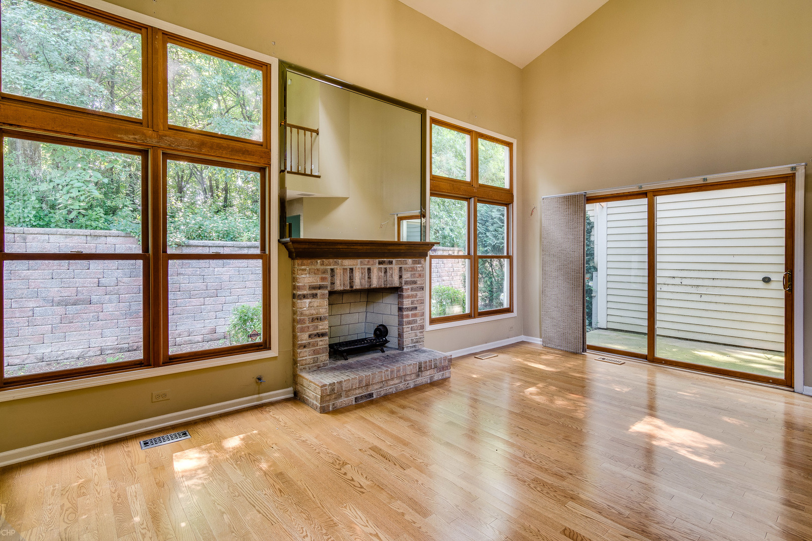 310 Spring Creek Circle Schaumburg, IL 60173 - Photo 12 of 26 a view of an empty room with a fireplace and a window