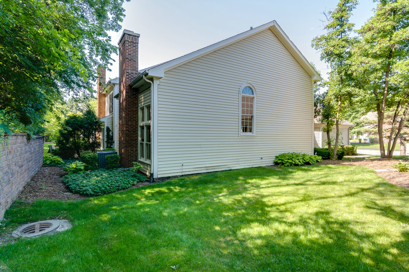 310 Spring Creek Circle Schaumburg, IL 60173 - Photo 3 of 26 a backyard of a house with plants and large tree