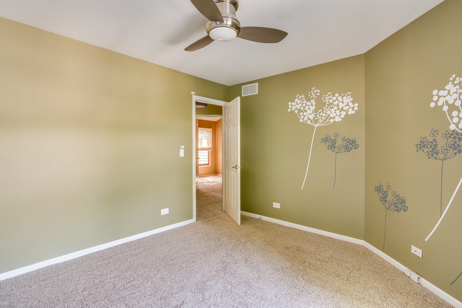 310 Spring Creek Circle Schaumburg, IL 60173 - Photo 22 of 26 an empty room with a chandelier fan and windows
