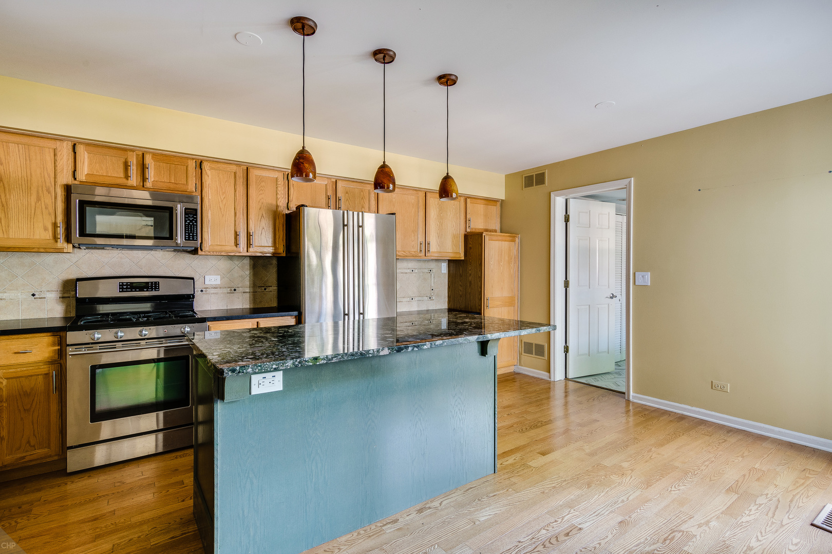 310 Spring Creek Circle Schaumburg, IL 60173 - Photo 7 of 26 a kitchen with stainless steel appliances a refrigerator a stove top oven a sink and a chandelier